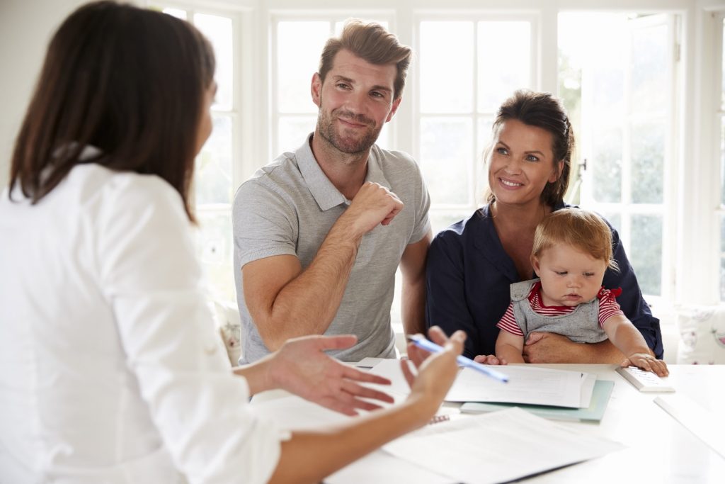 family with baby  meeting financial advisor at home