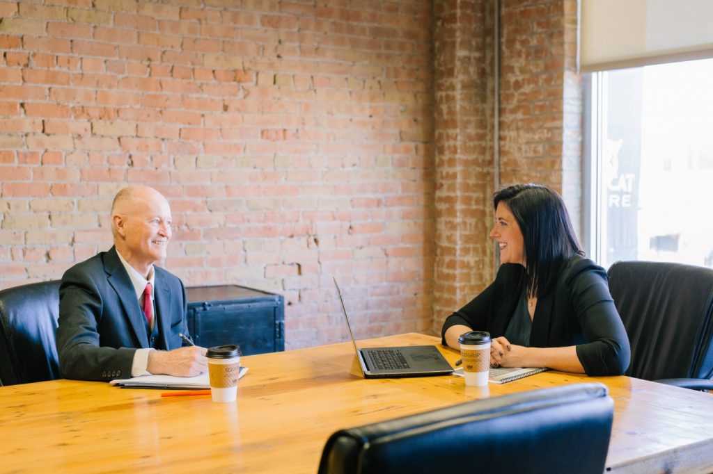 man and woman at job interview in conference room
