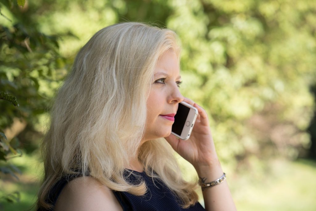 blonde woman talking on the smartphone