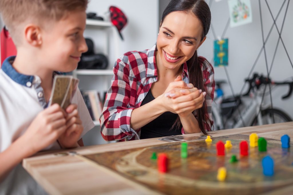 Mother and son playing modern board game