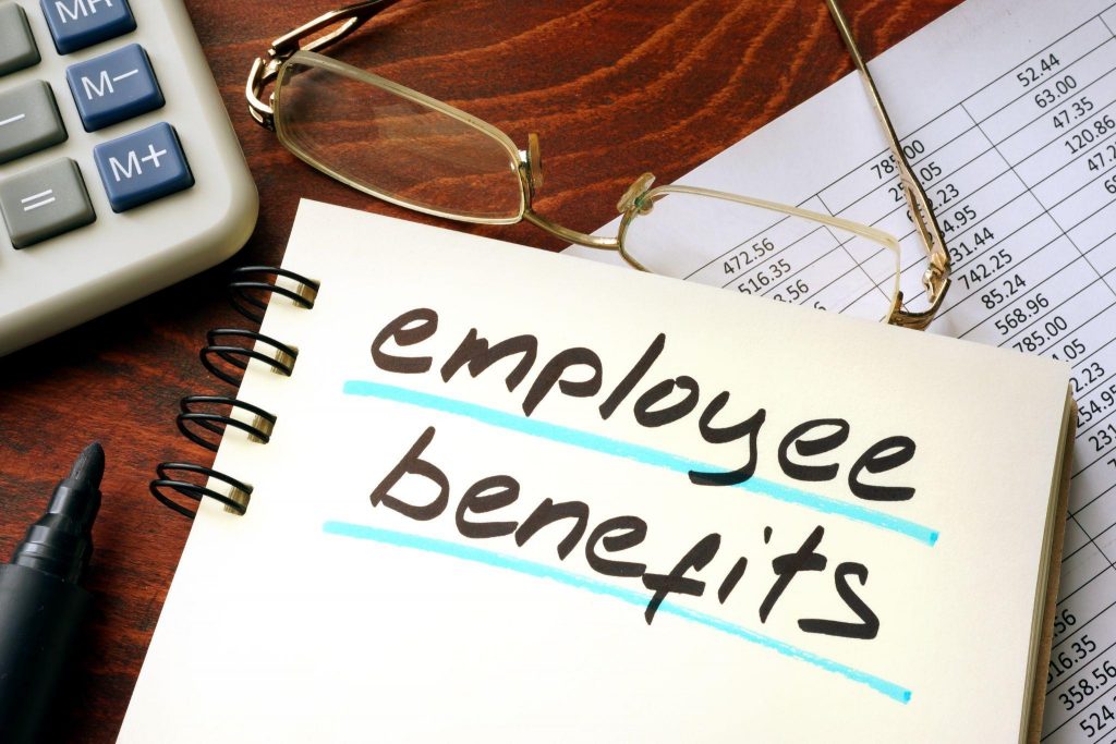 Employee benefits written on a notepad