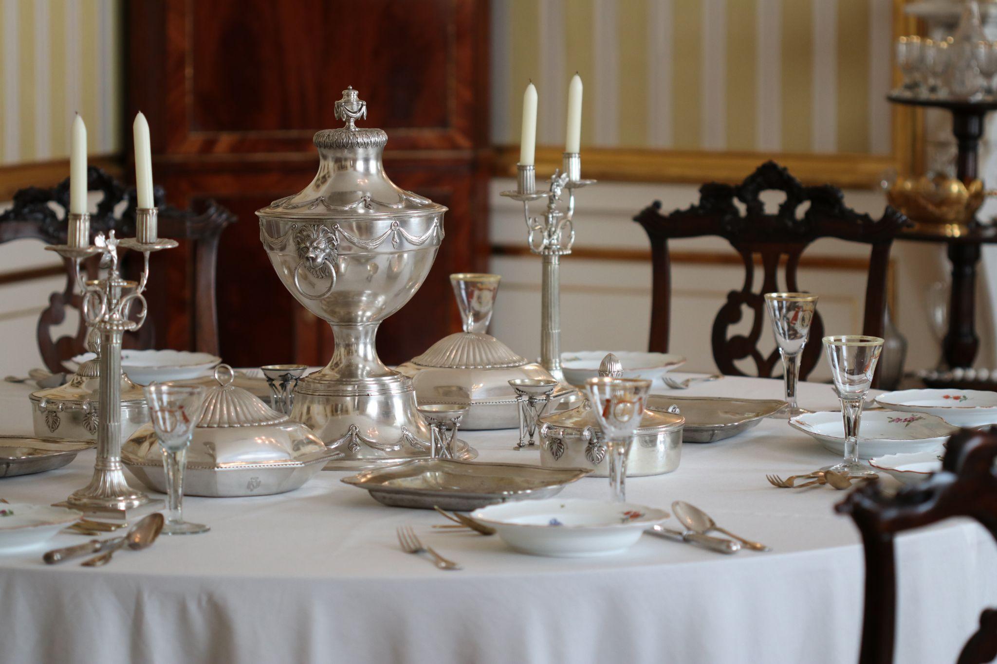 Fine silver assets set on a table by a butler