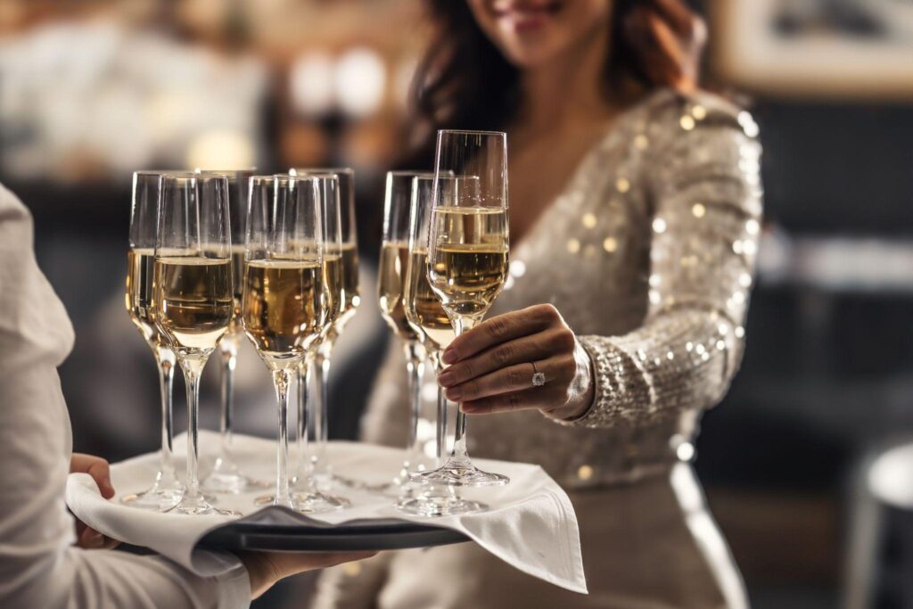 Butler serving champagne at a celebrity home