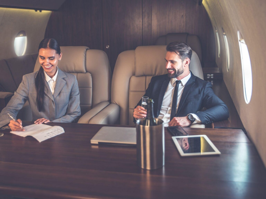 Executive assistant and boss having a meeting on a private jet