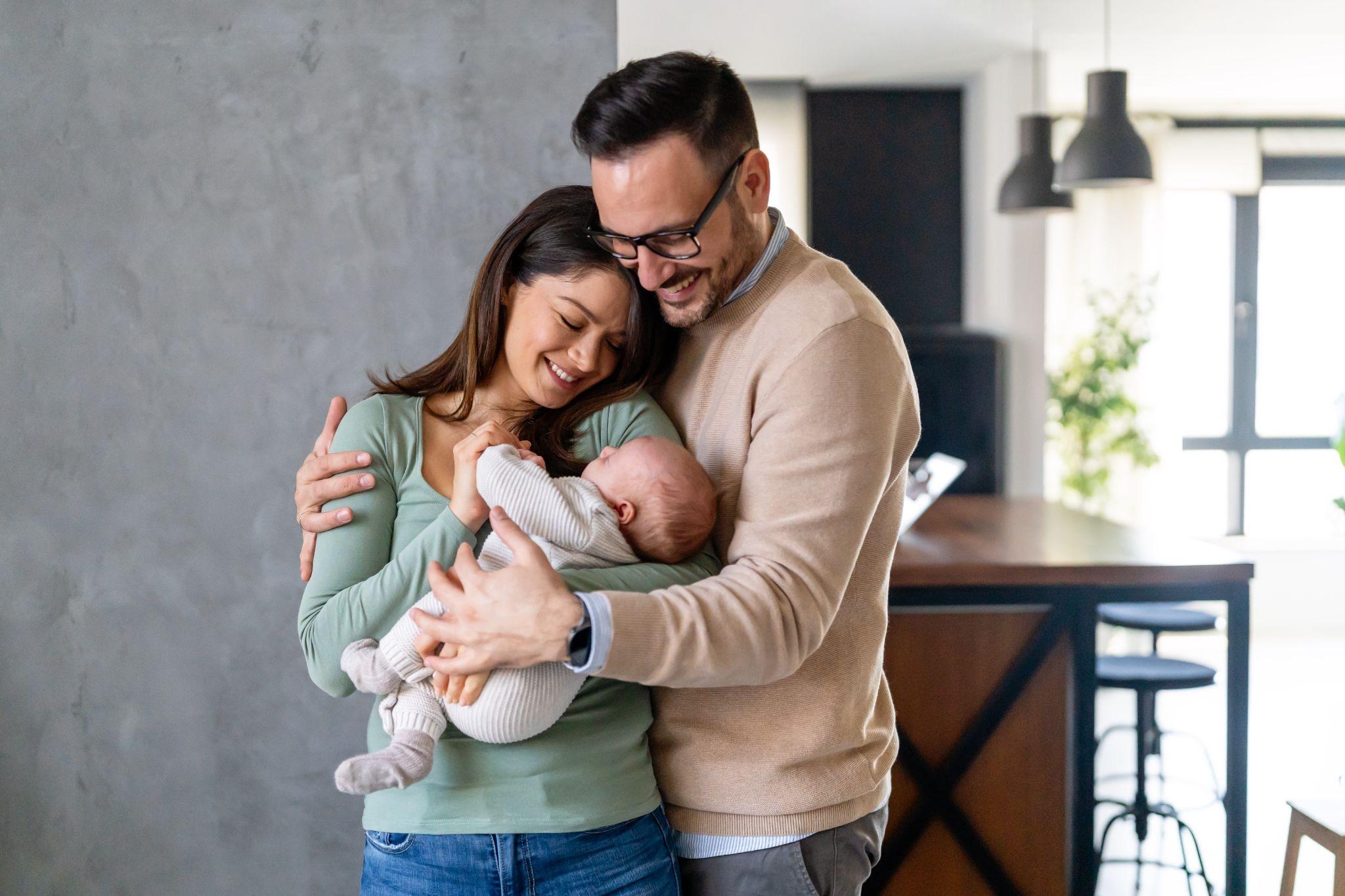 New parents holding a baby