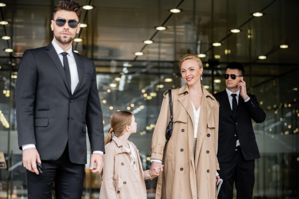 Celebrity woman walking with her daughter and private security